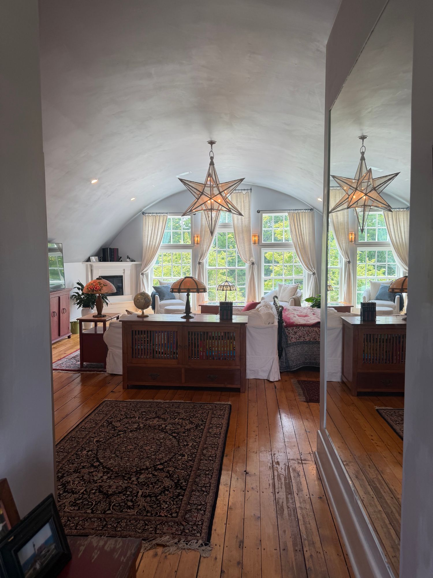 The primary suite with a soaring vaulted ceiling and star pendant light